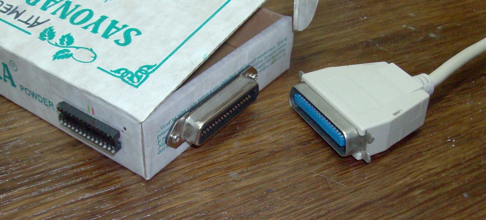 A parallel port cable and box of Savlon antiseptic powder represent vintage technology.